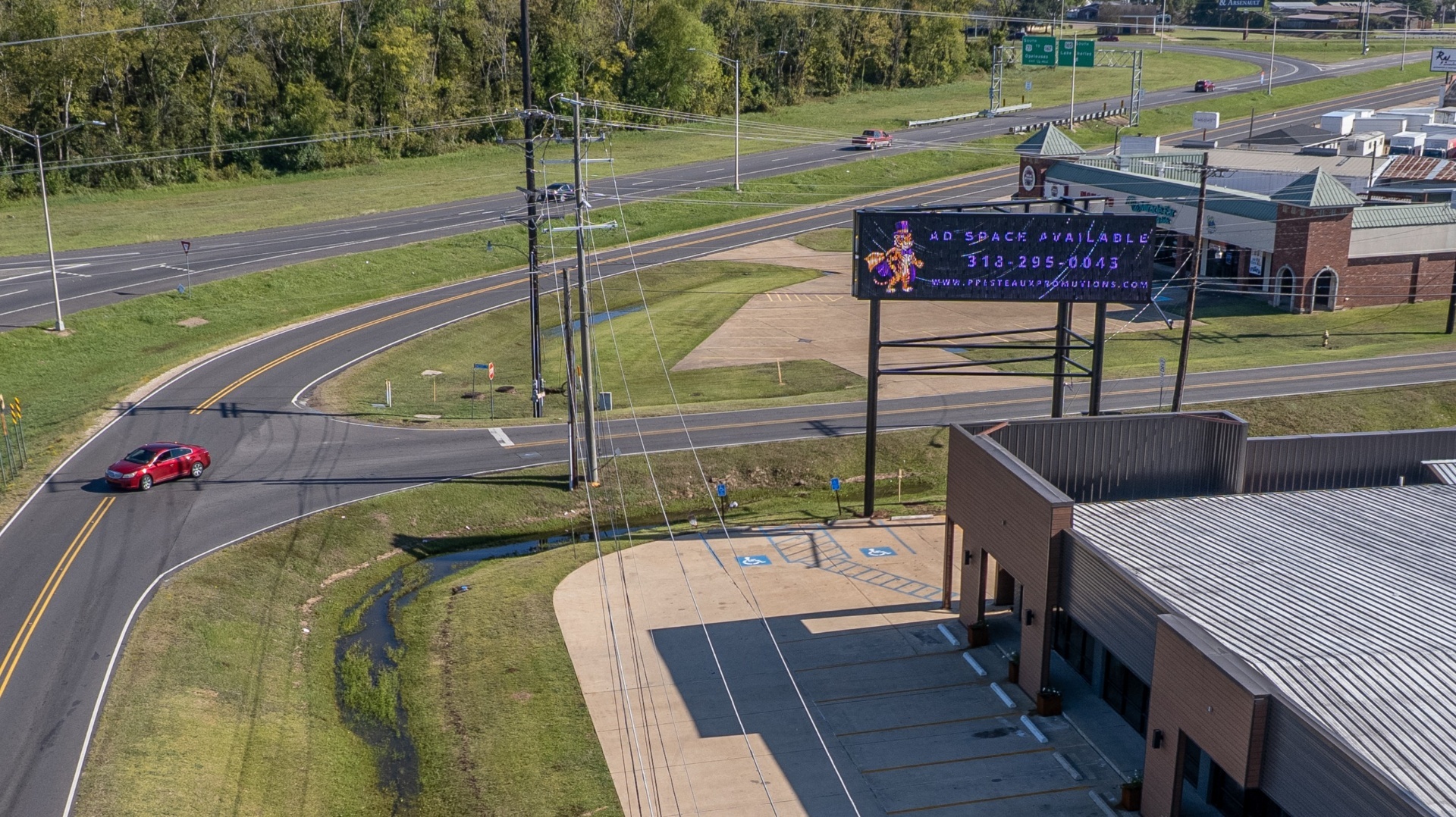 Presteaux Promotions LED billboard displaying ad space available near highway interchange